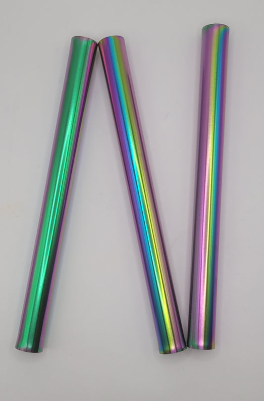 3 Multicolored cylindrical cat-eye magnets spreaded apart on a gray background