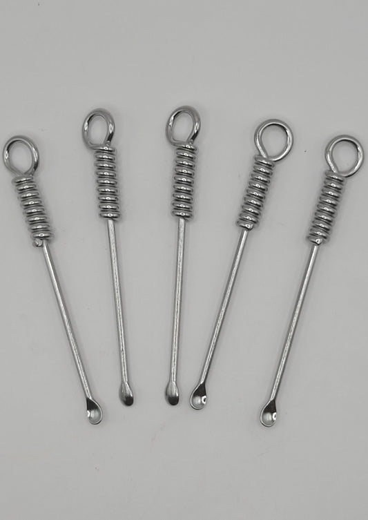 Five silver metal mini spoons for mica or glitter scooping on a gray background