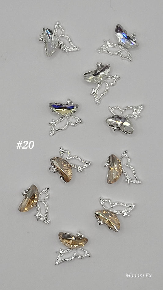 10 piece Collection of decorative charms light brown and clear blue reflective on a gray background