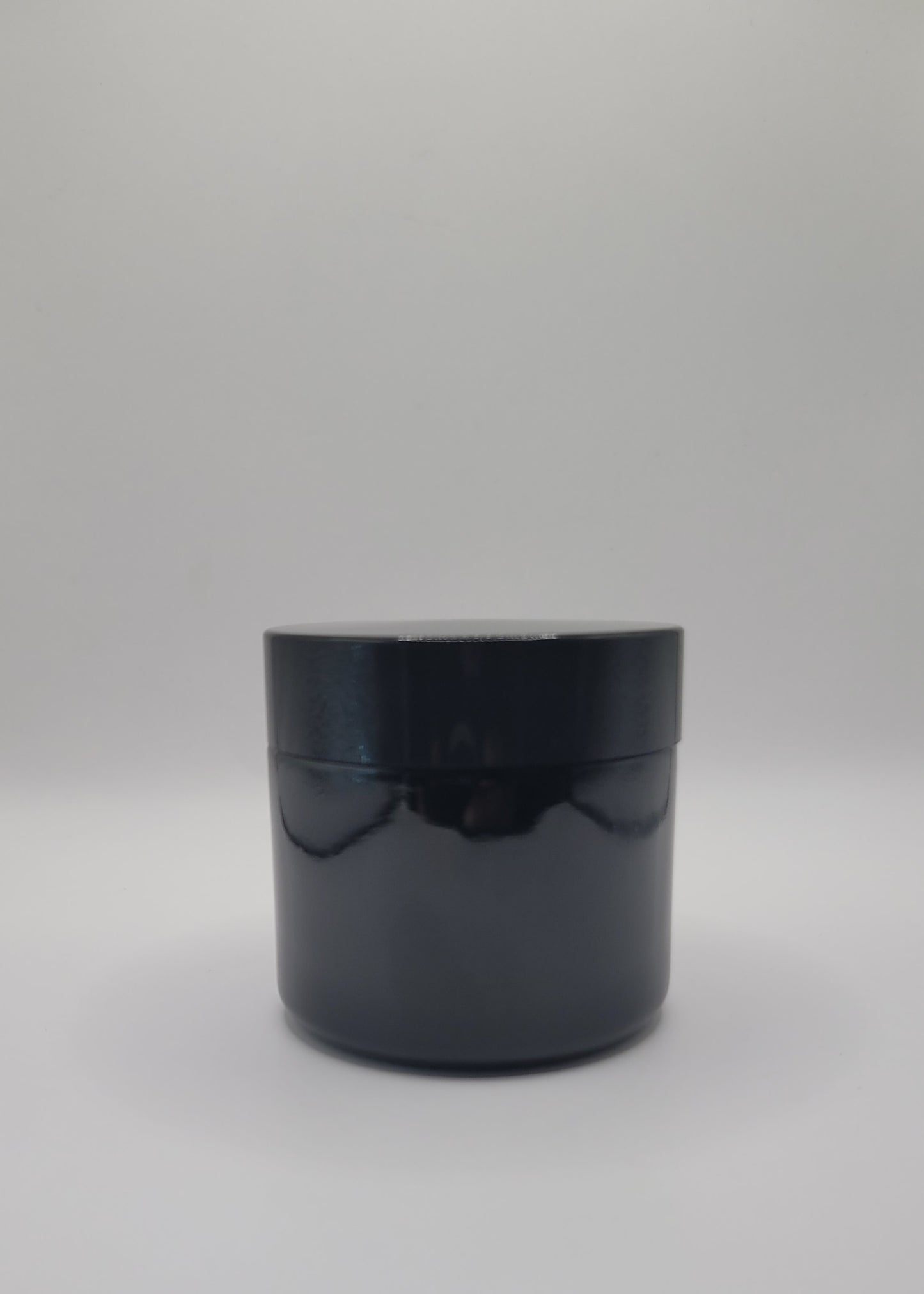 Black cylindrical container on a white background