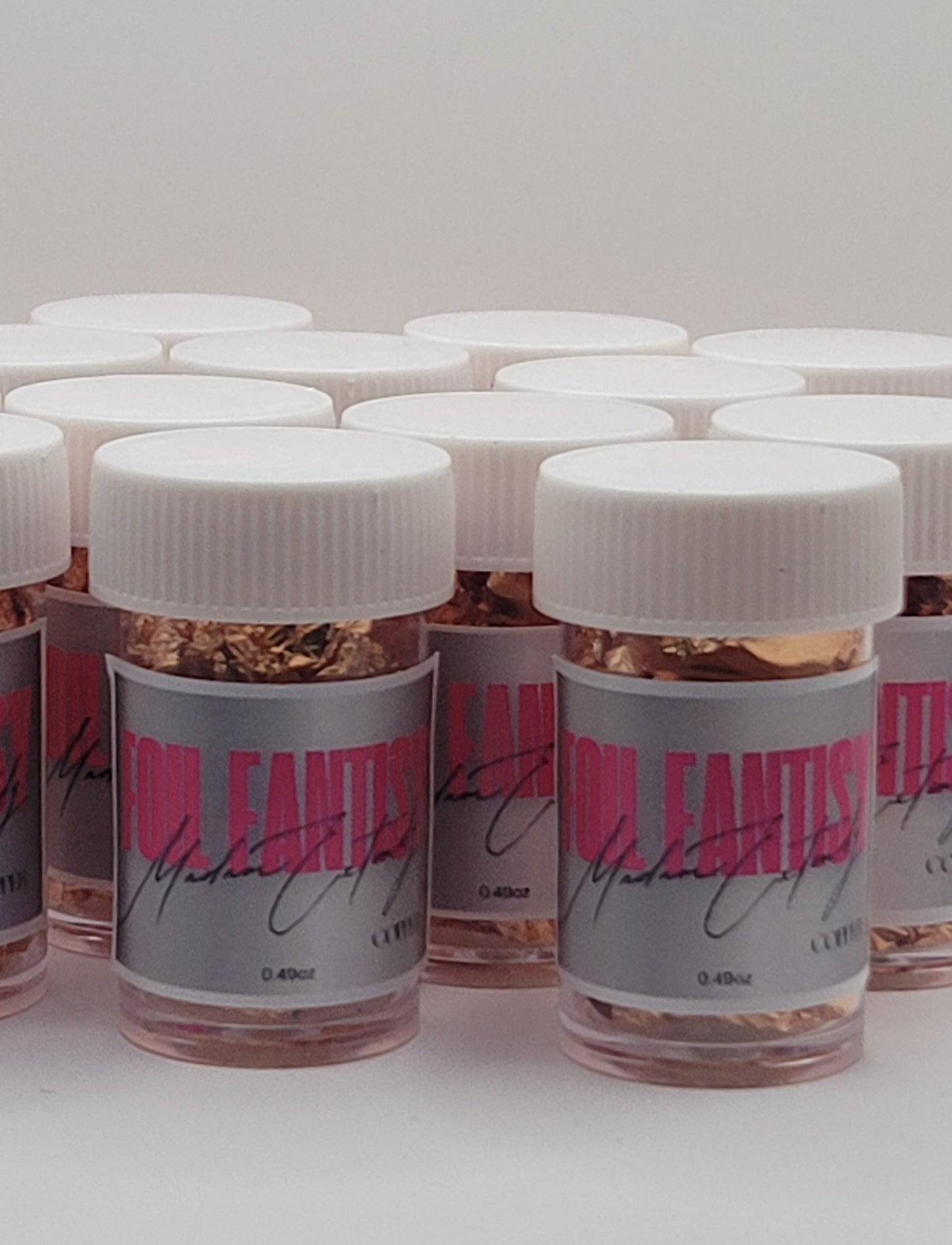a group of Jars with white lids and gray labels with Fatasy Foil in pink text on a white background