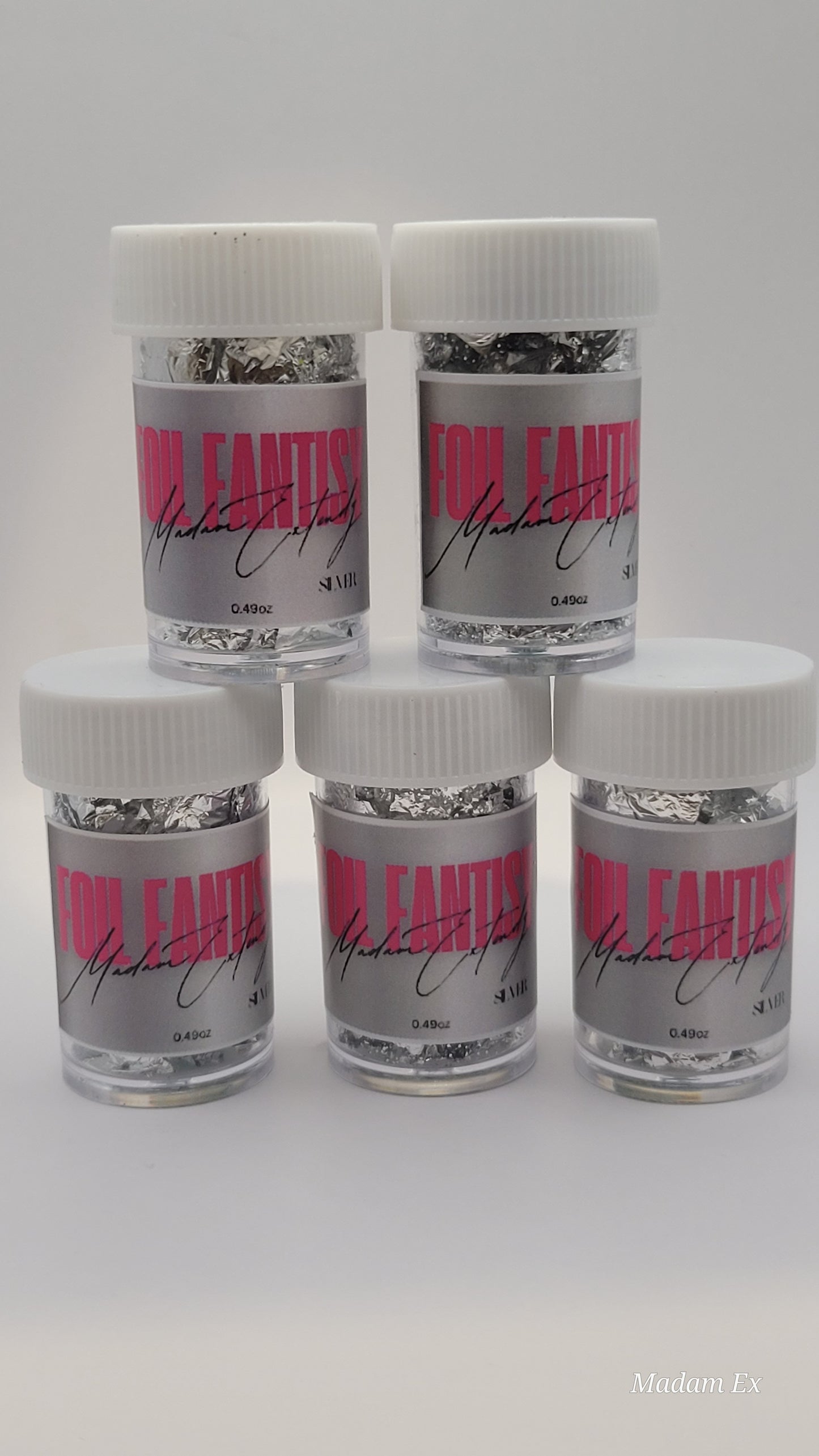 five containers of silver foil fantasy with pink labels on a white background