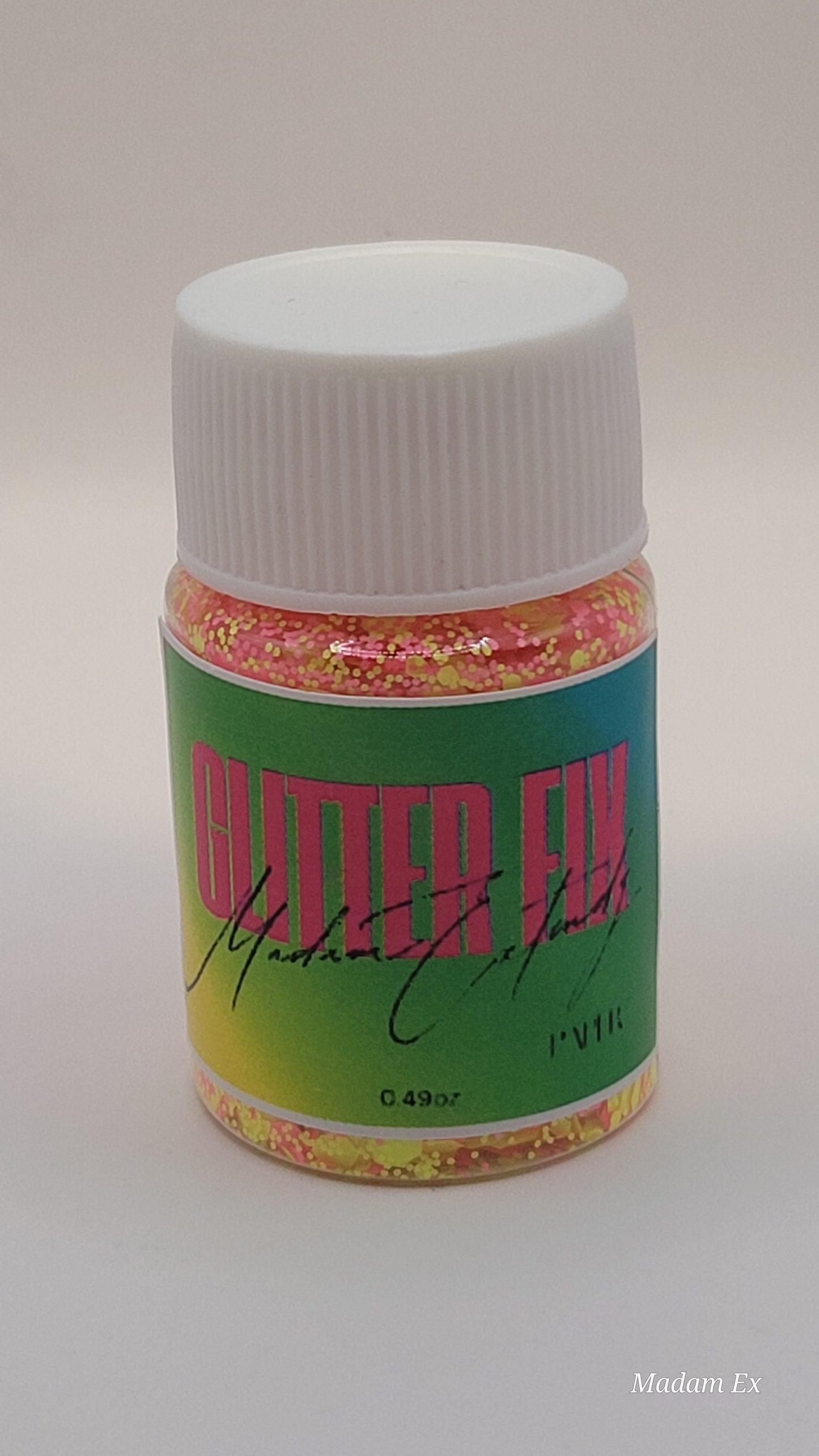 Bottle of Pink & Yellow Glitter Fix with green label and pink contents on a white background