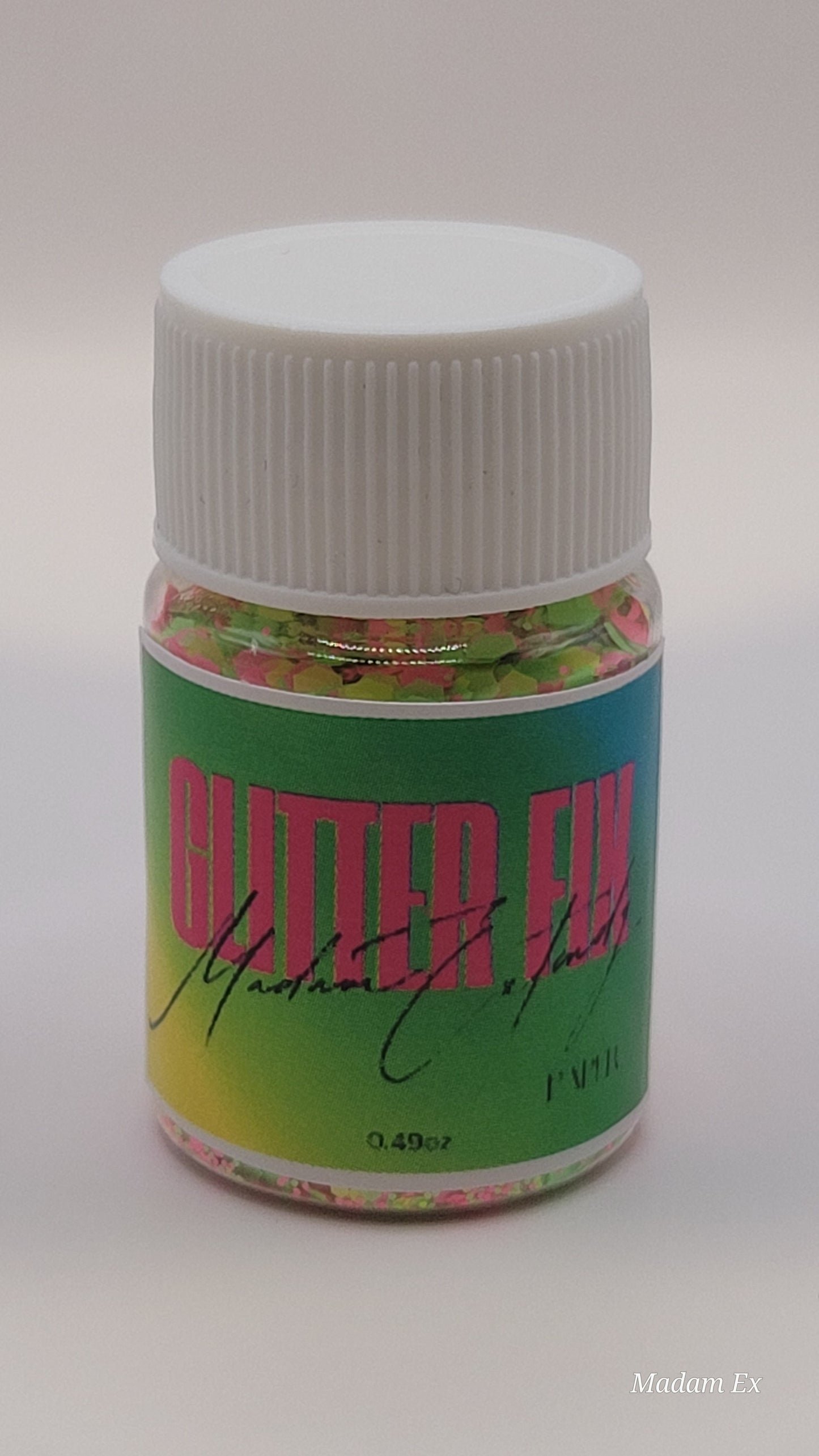 Bottle of mixed Glitter Fix with green label and pink contents on a white background