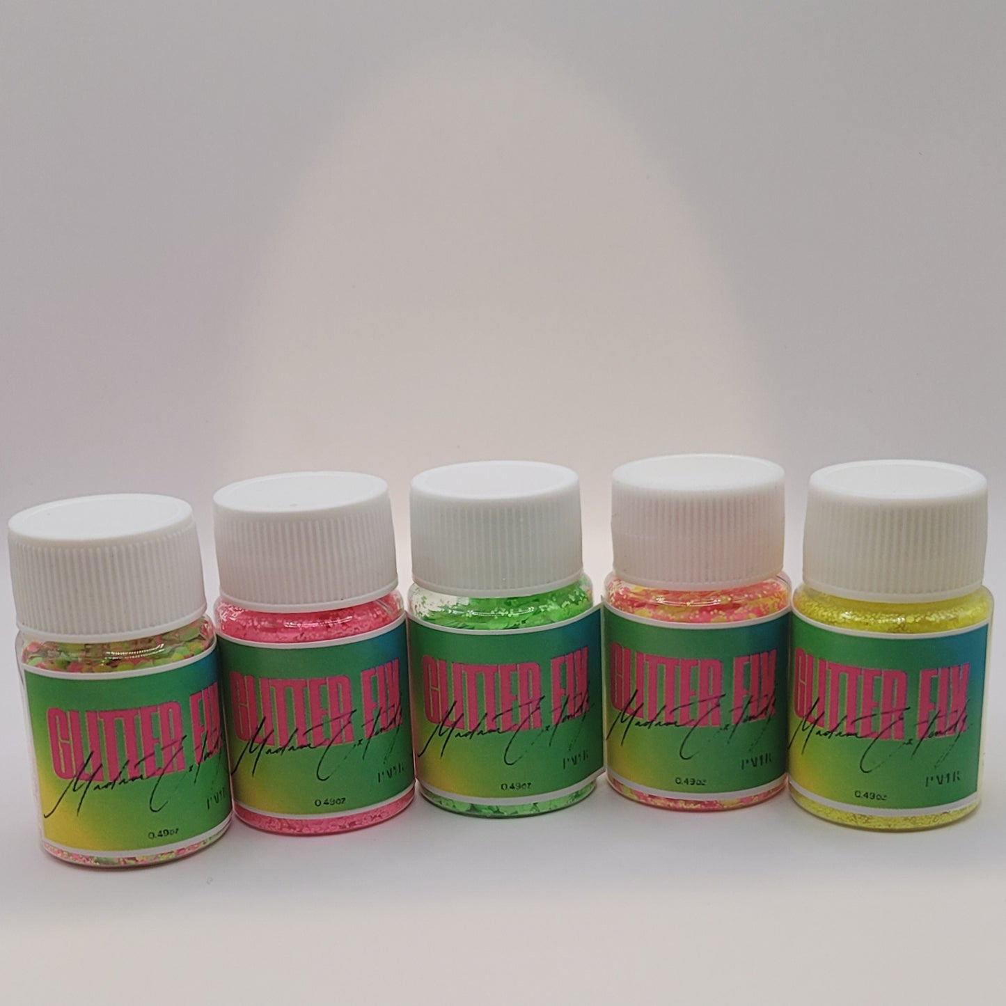 five bottles of Glitter Fix with green label and pink contents on a white background