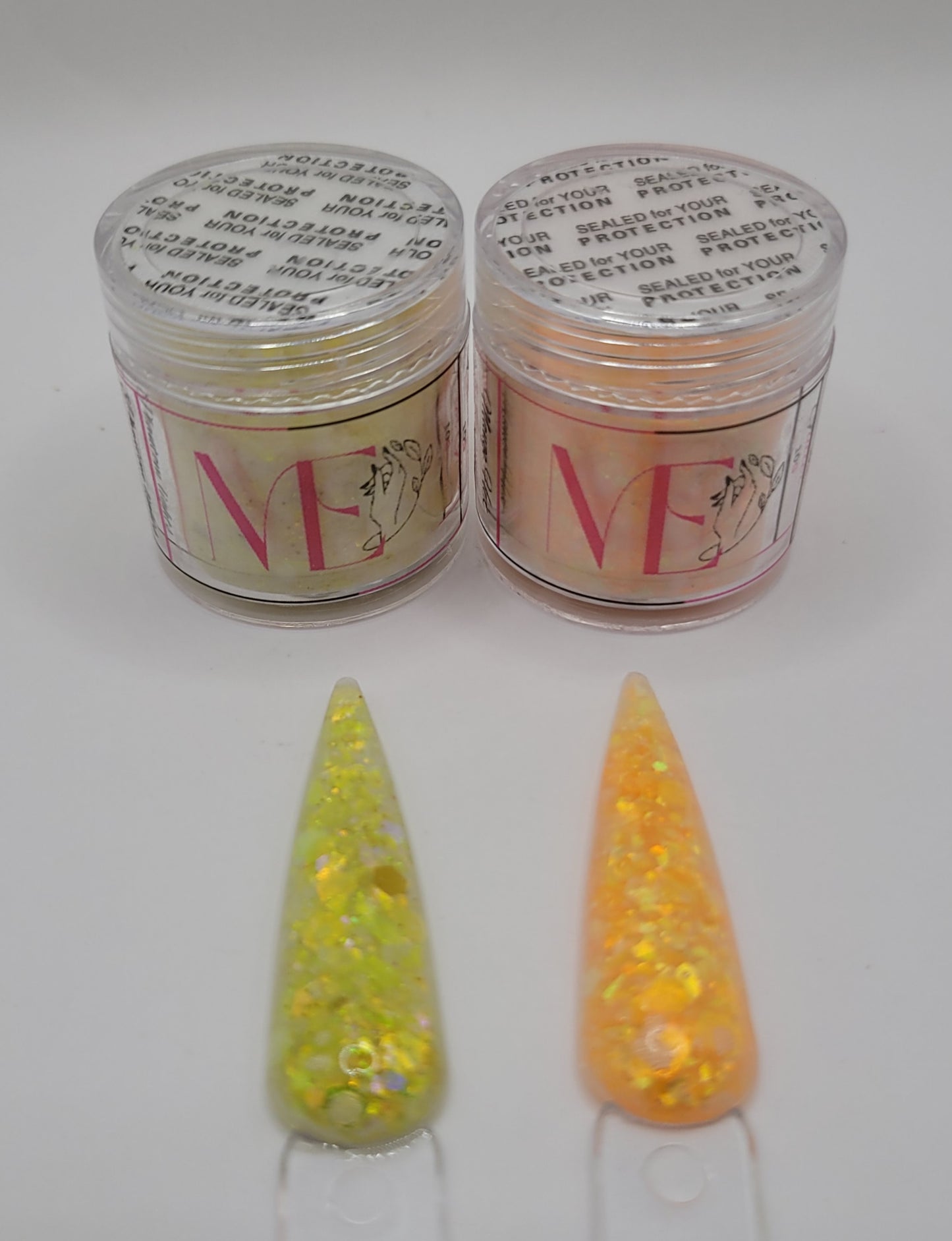 Two jars of glitter acrylic with labels and two glittery nail swatches on a white background