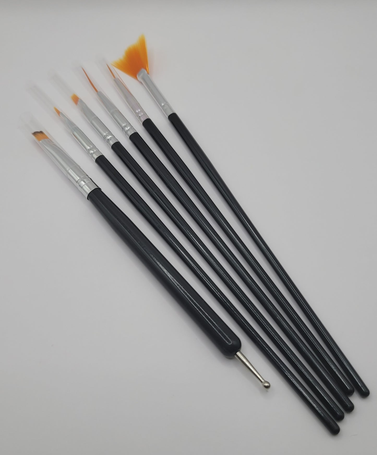 6pcs orange tip black and silver nail art brush set on a white background
