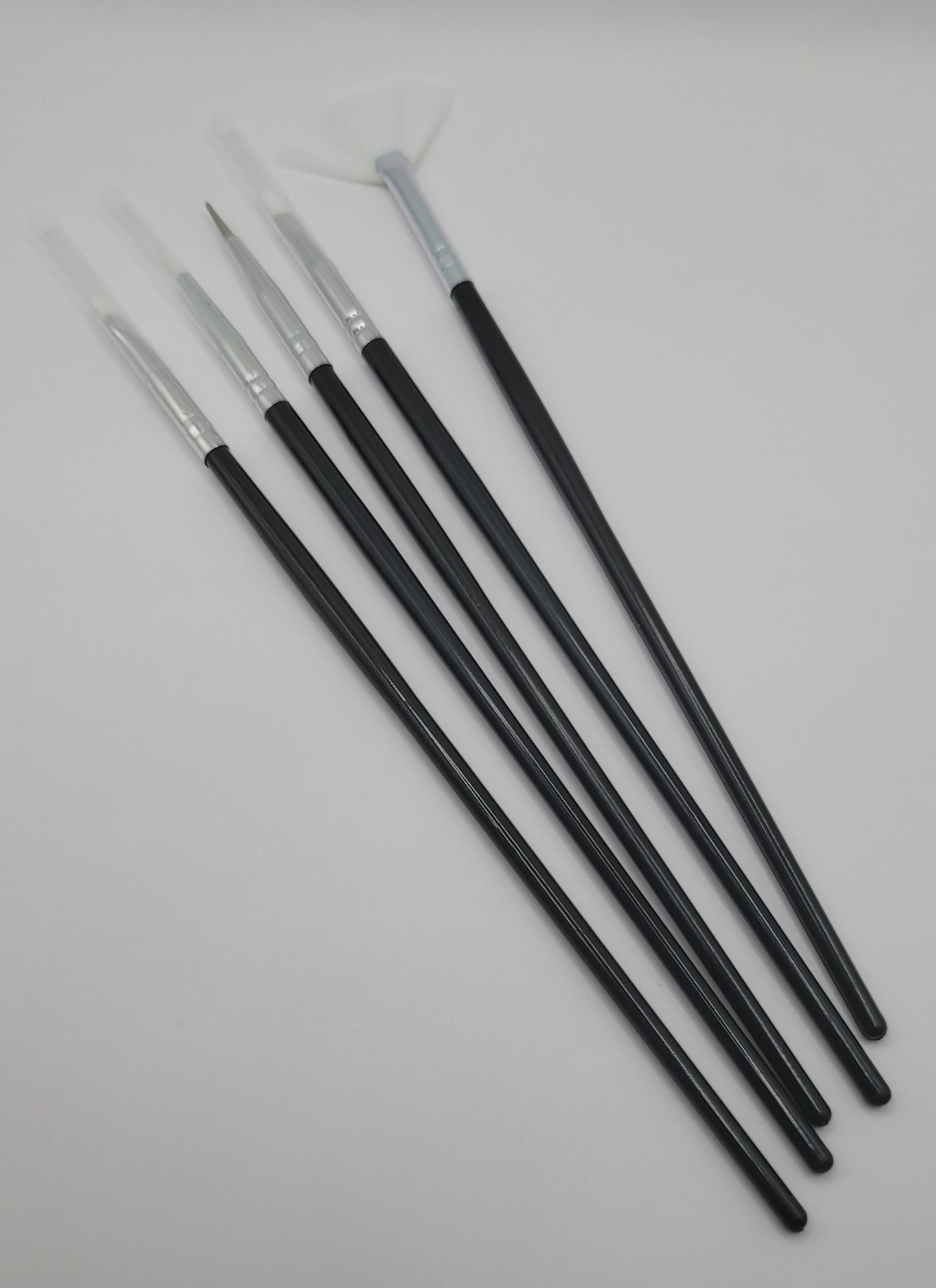 5pcs white tip black and silver nail art brush set on a white background