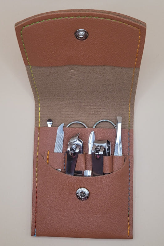 brown travel sized manicure set opened white background