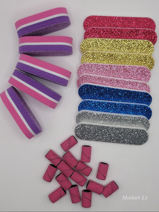 Assorted nail prep kit in various colors with drill bands files and buffers on a white background.