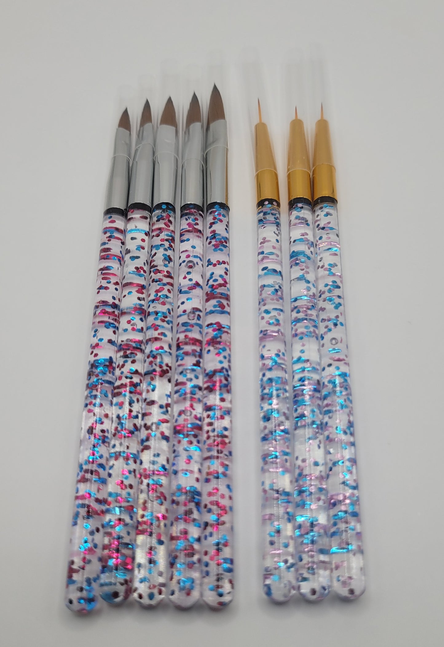 five piece acrylic brush set and tree piece nail art brush set on white background
