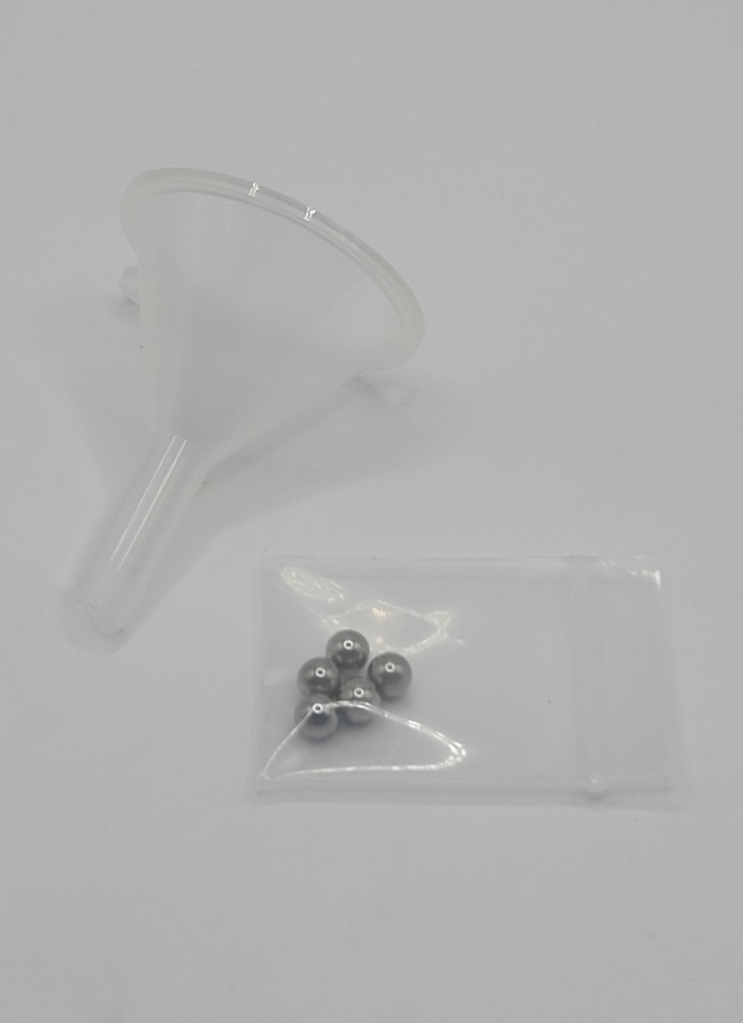clear funnel and mixing beads on white background