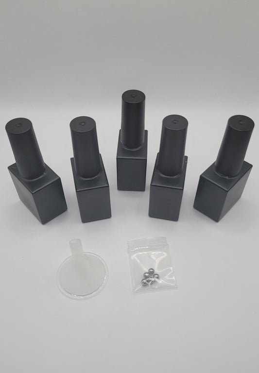 5 Sets of black glass nail polish bottles on a white background with a clear plastic funnel and stiring beads