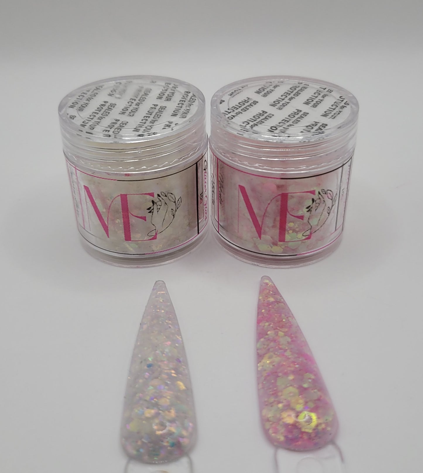 Two jars of glitter acrylic with labels and two glittery nail swatches on a white background