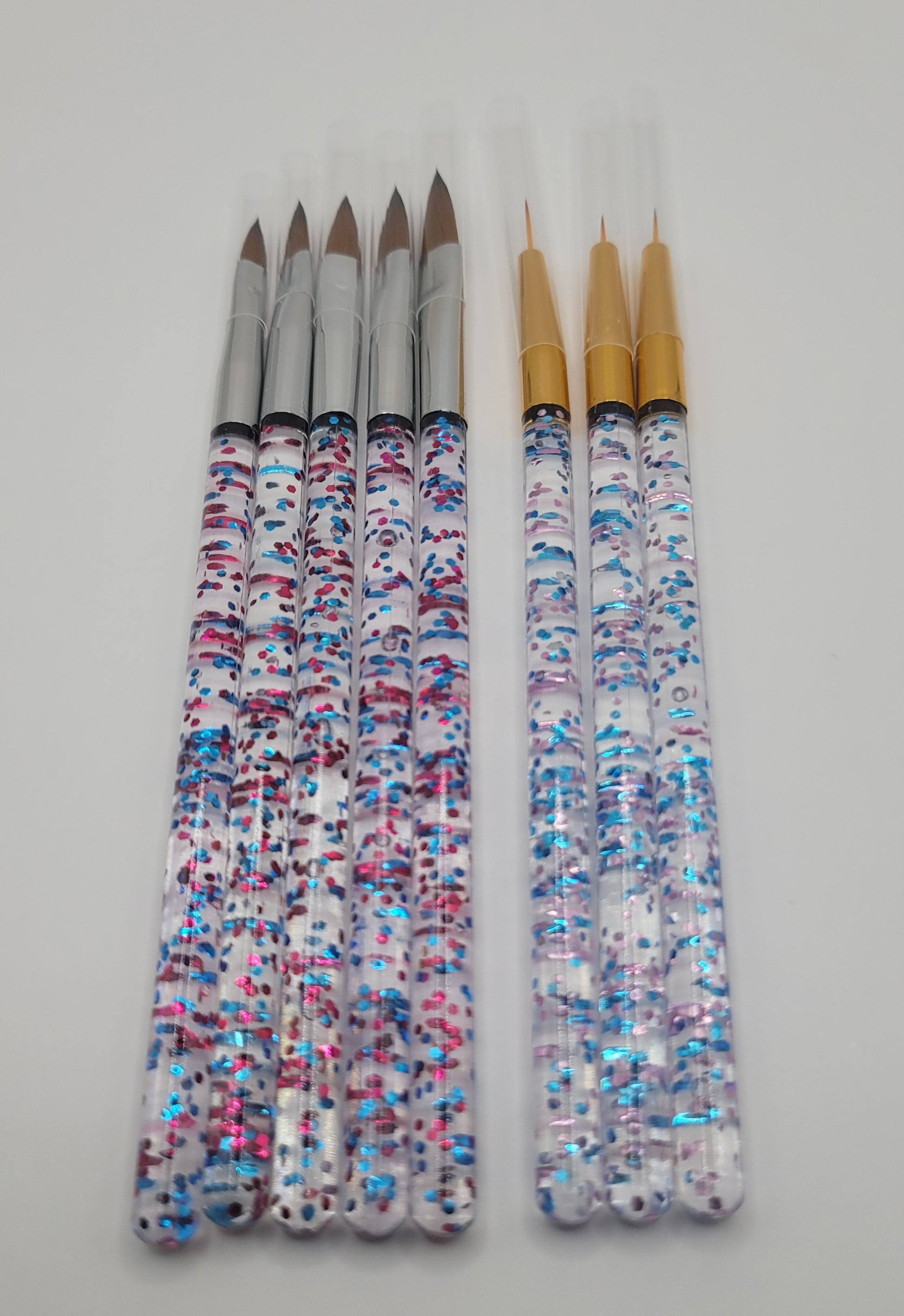 five piece acrylic brush set and tree piece nail art brush set on white background