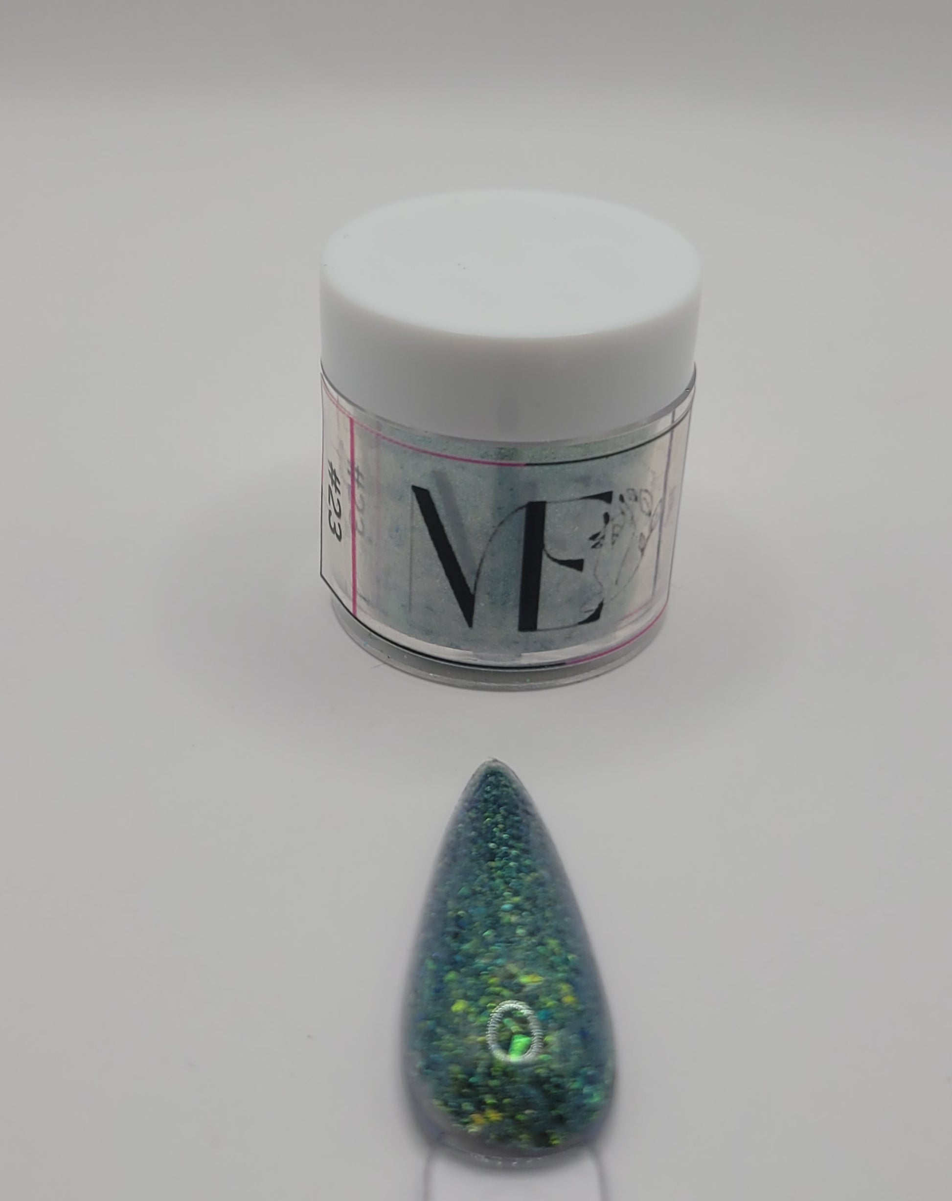 1 Jar of chameleon glitter Acrylic powder with 'ME' branding and a nail art swatchstick samples on a white background