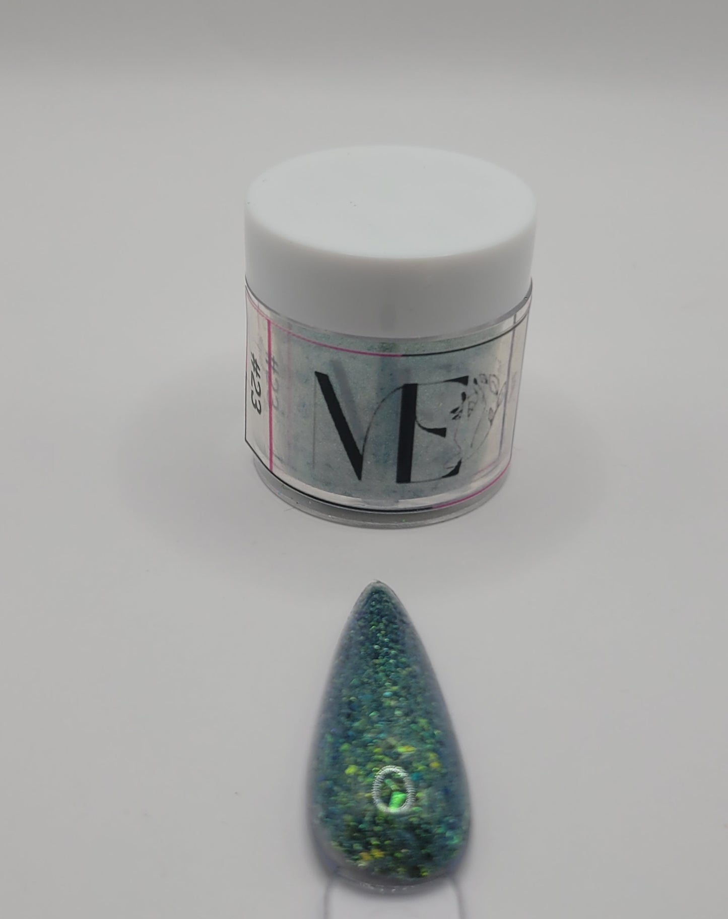 1 Jar of chameleon glitter Acrylic powder with 'ME' branding and a nail art swatchstick samples on a white background