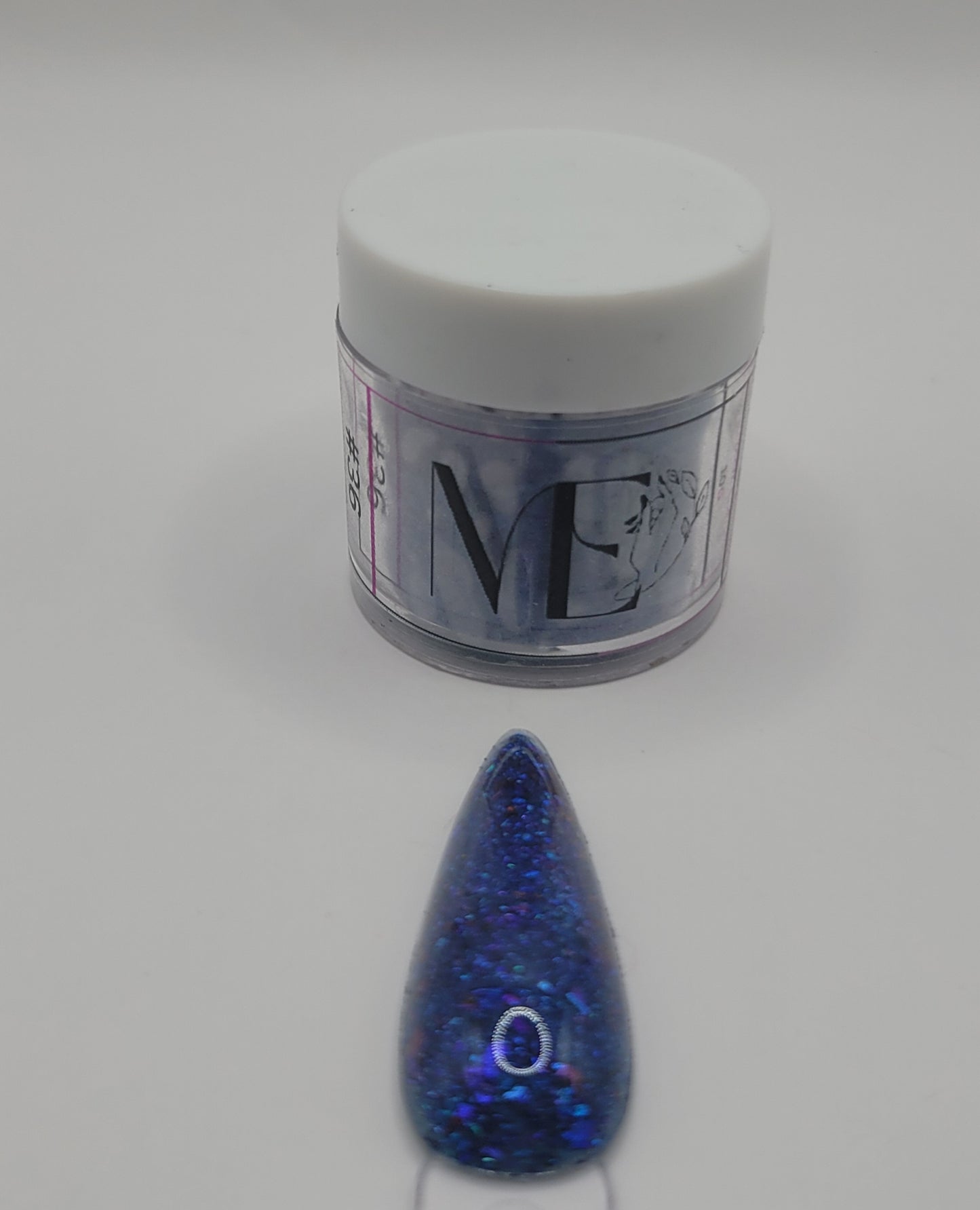 1 Jar of chameleon glitter Acrylic powder with 'ME' branding and a nail art swatchstick samples on a white background