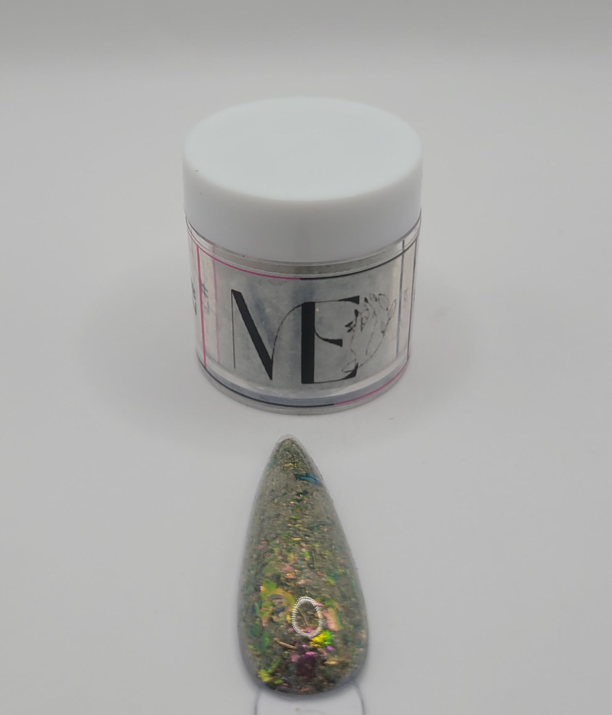 1 Jar of chameleon glitter Acrylic powder with 'ME' branding and a nail art swatchstick samples on a white background