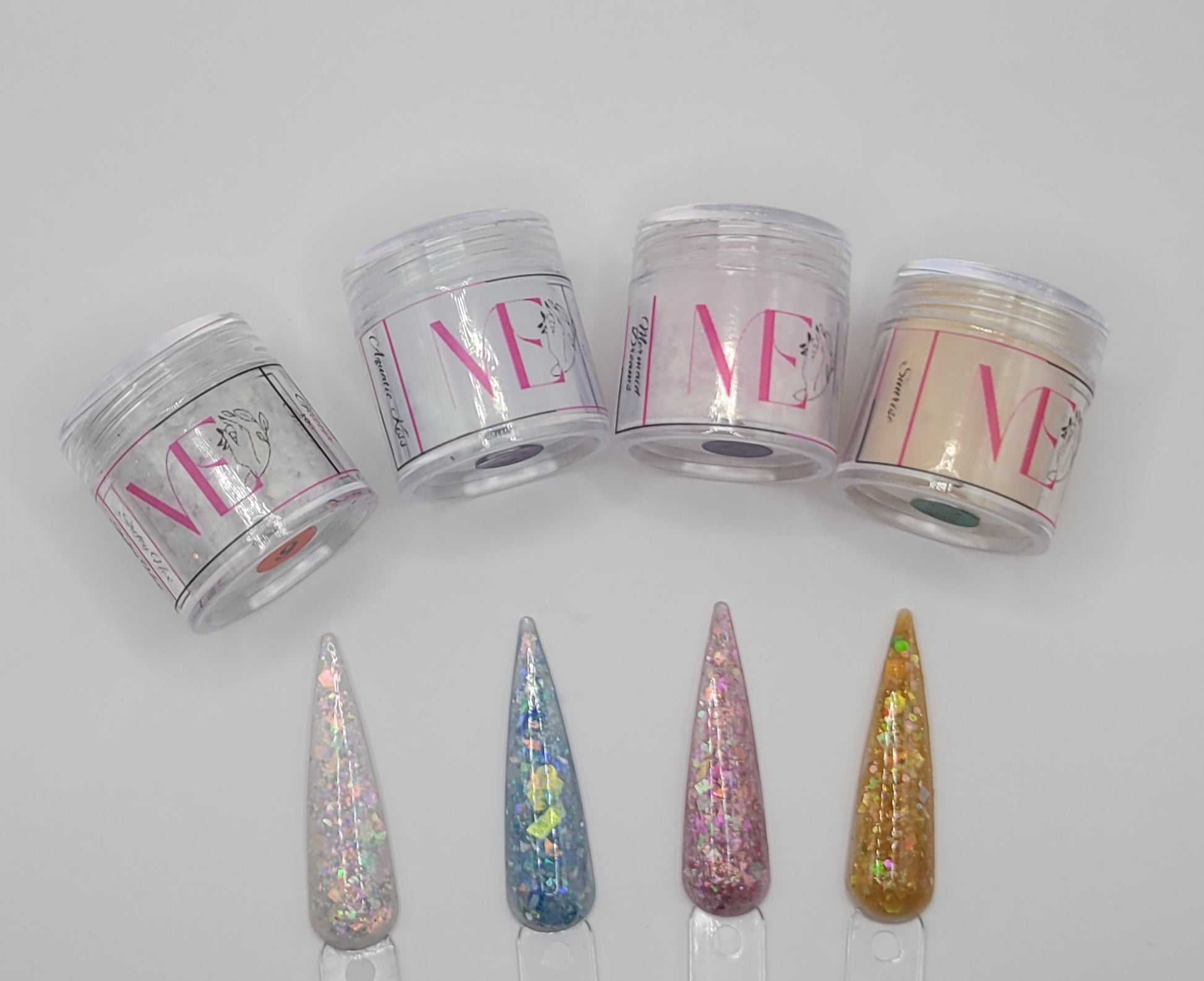 Four jars labeled 'ME' with decorative swatchsticks in front on a white background