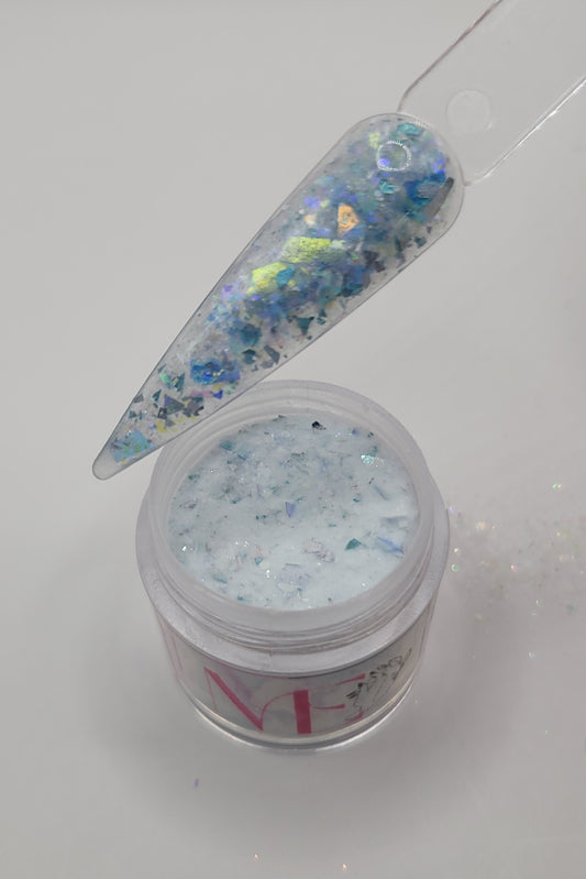 open Jar of blue decorative glitter foil acrylic mix top opened with a swatch stick over top on a white background