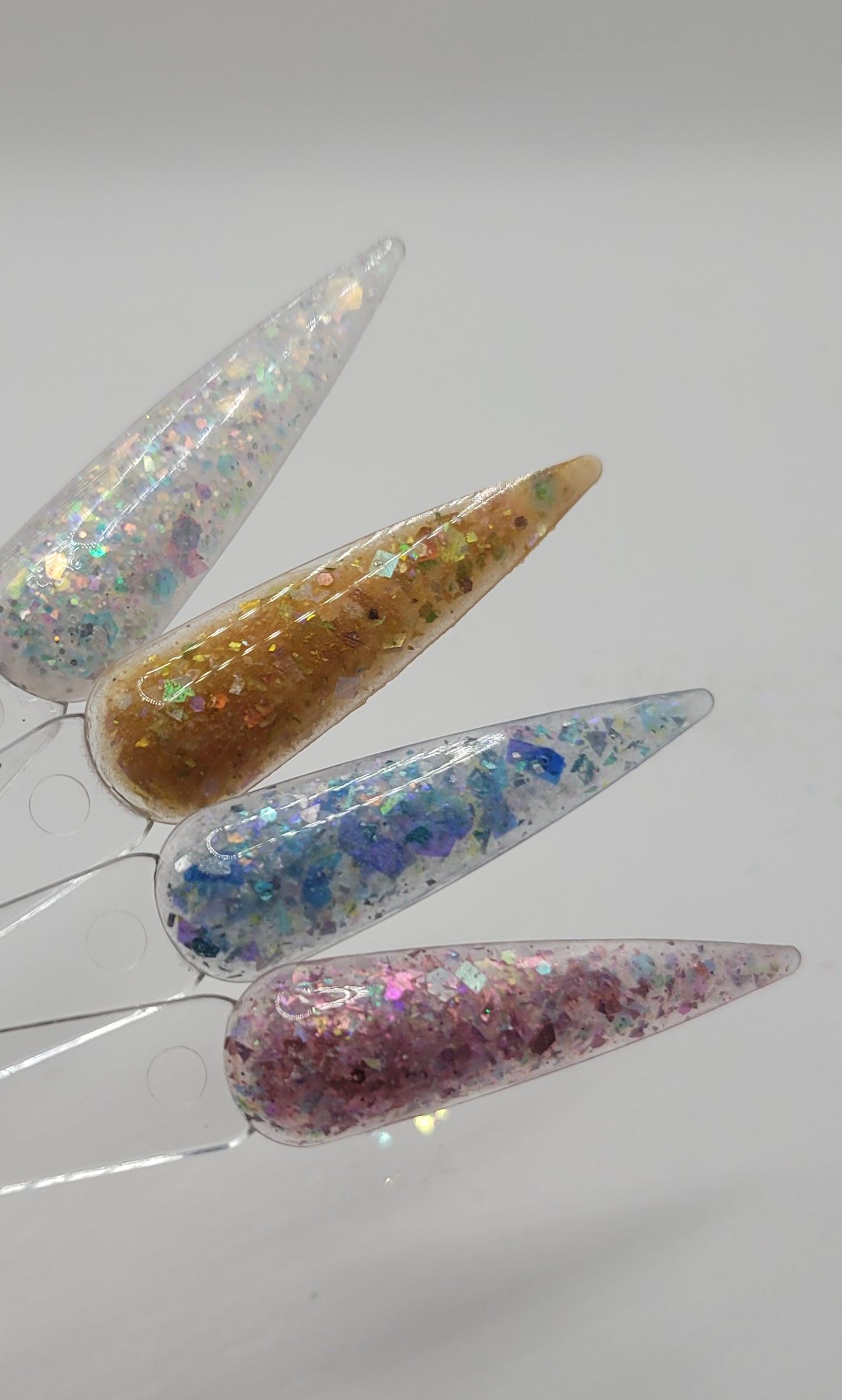 four swatchstick samples of mermaid acrylic powder against a white back ground.