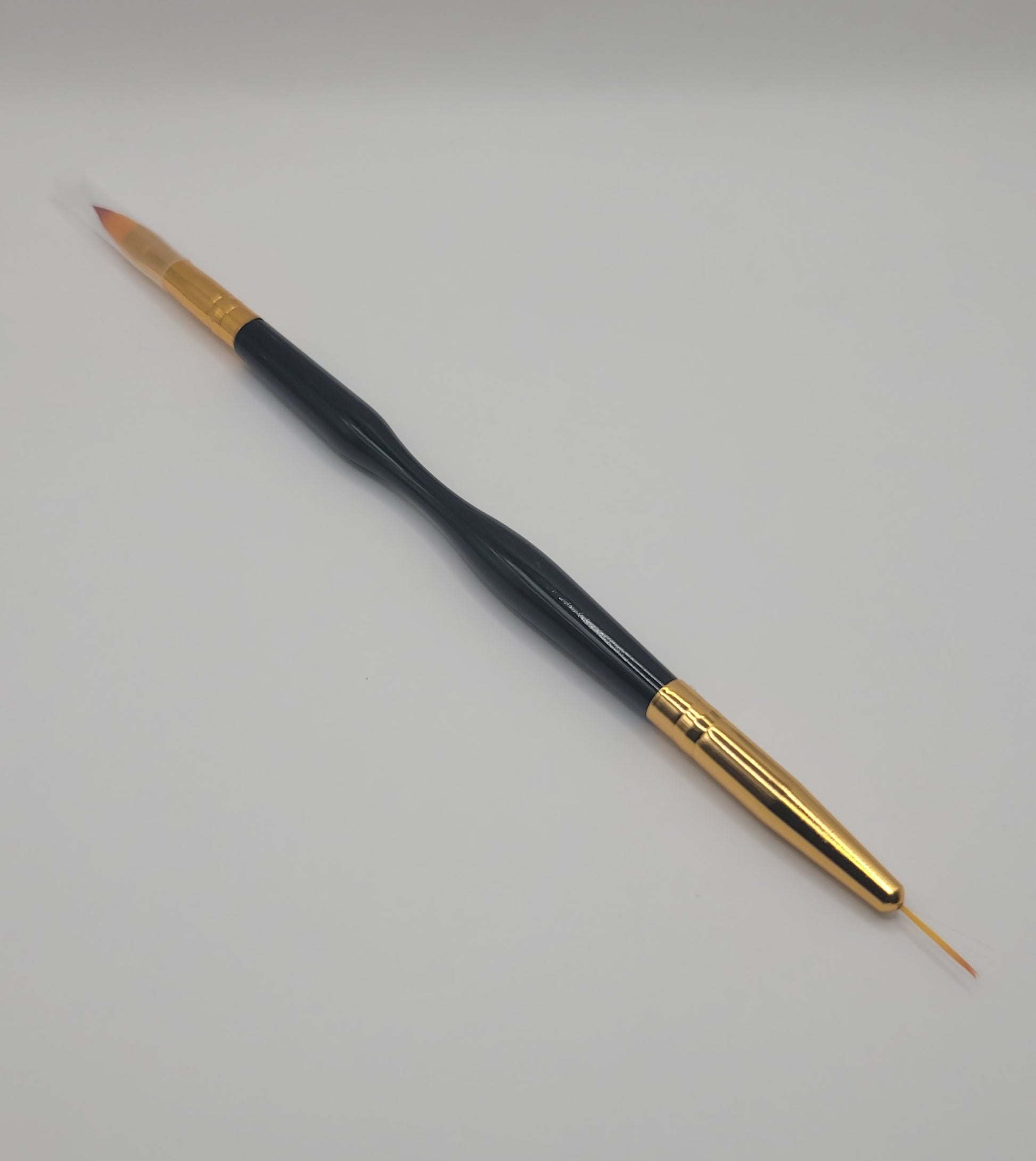 one large tip dual end black and gold nail art brush on white background