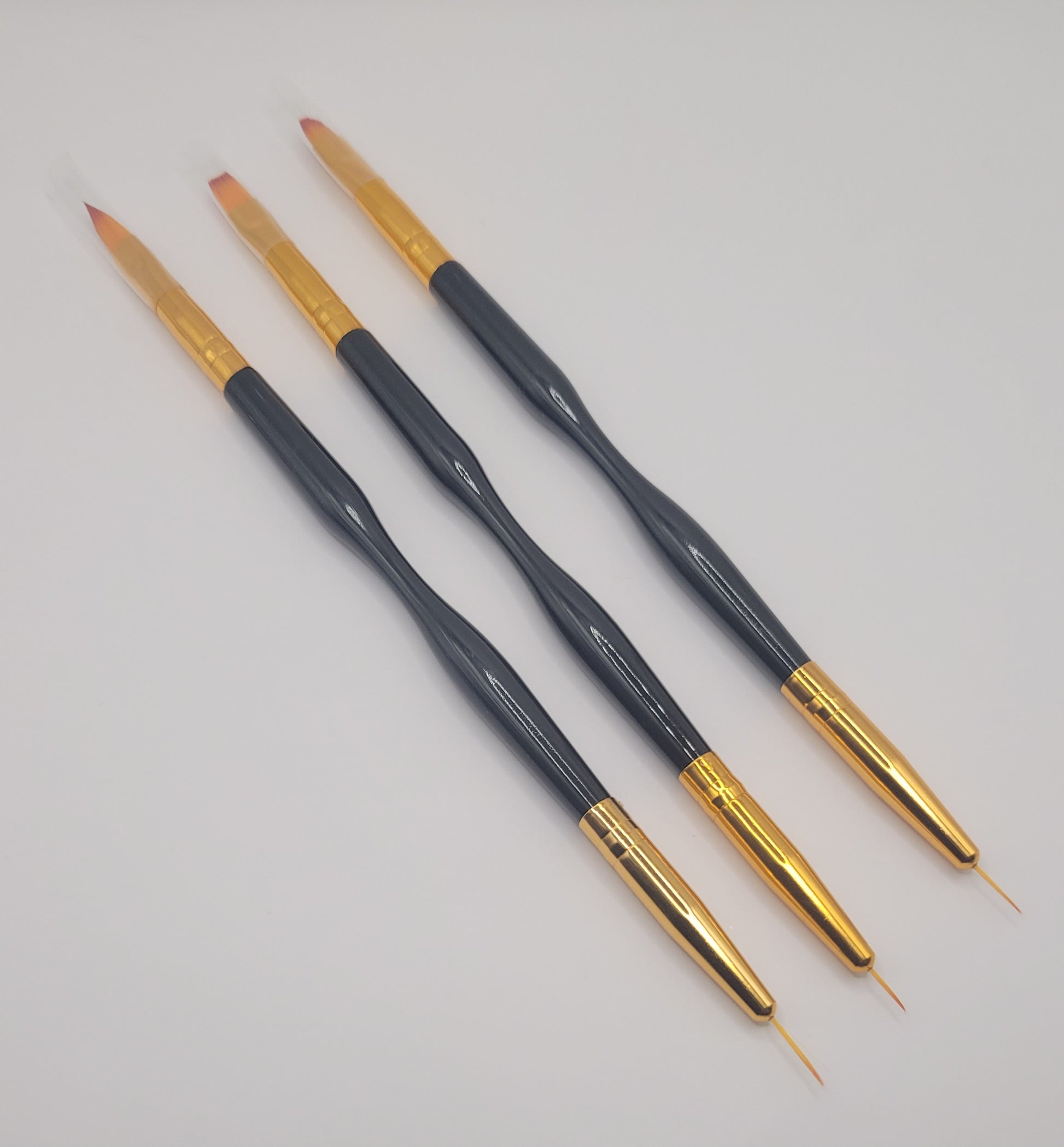 three small,medium, large dual end black and gold nail art brush on white background