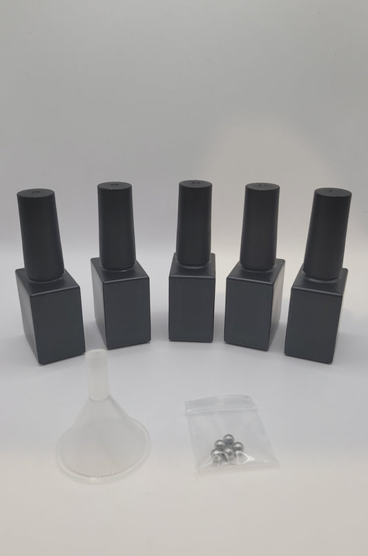 5 black square glass nail polish bottles with black cylindrical lids stiring beads and small clear funnel on a white background