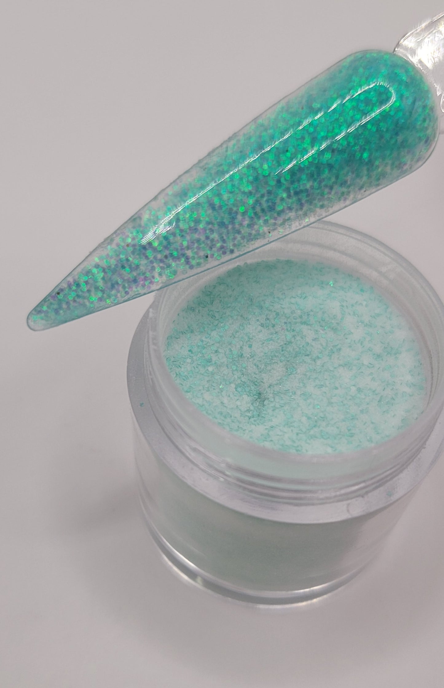 1 Jars of snow glitter acrylic powder with decorative 1 nail swatchsticks  on a white background